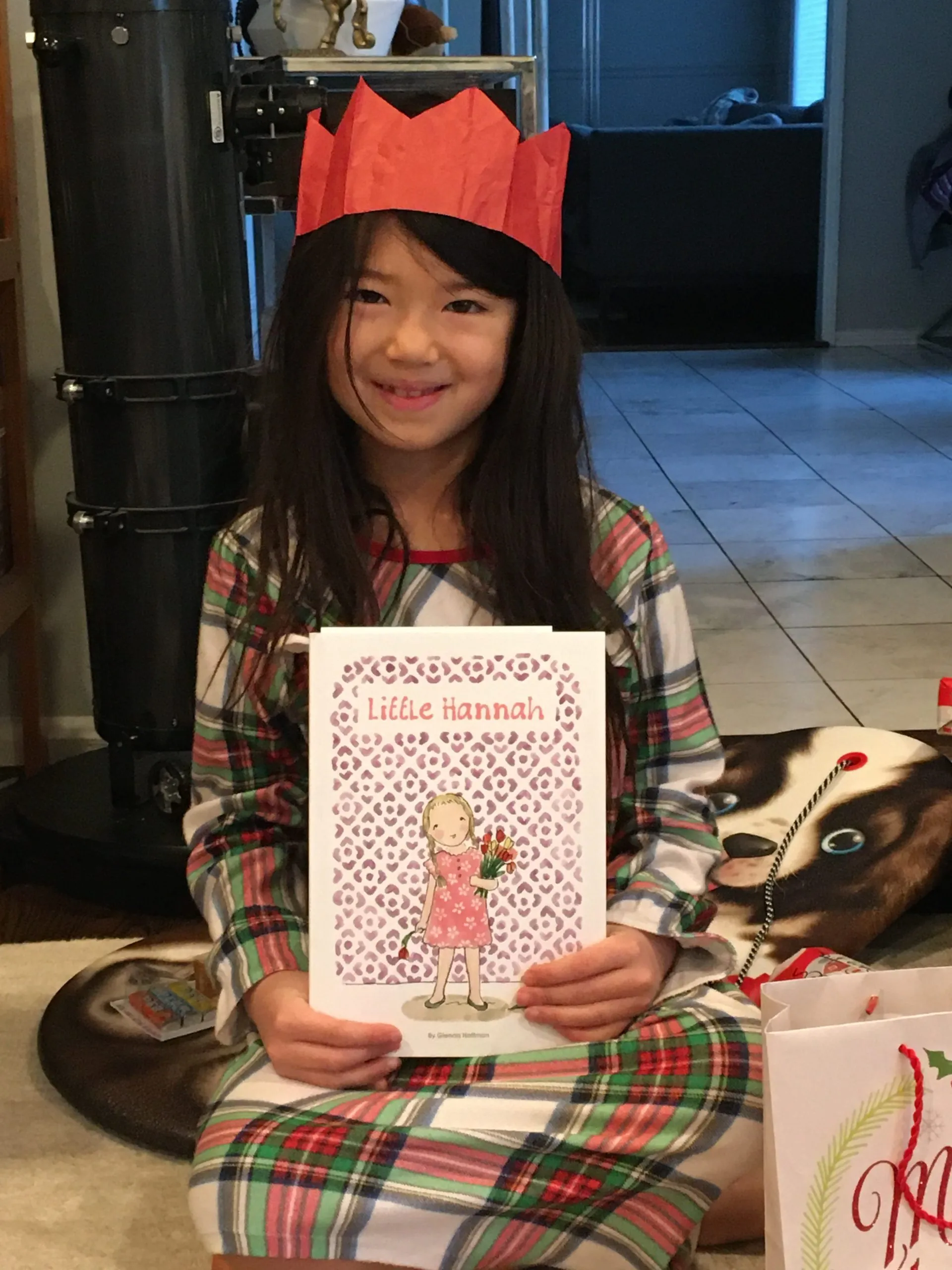 A little girl holding her copy of Little Hannah