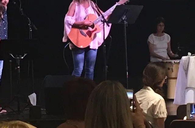 Glenda Hoffman introducing Little Hannah at a women's Christmas breakfast