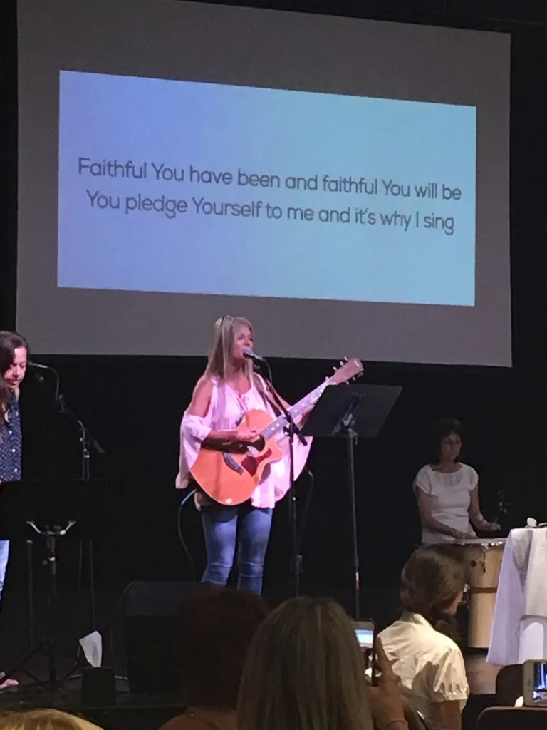 Glenda Hoffman introducing Little Hannah at a women's Christmas breakfast